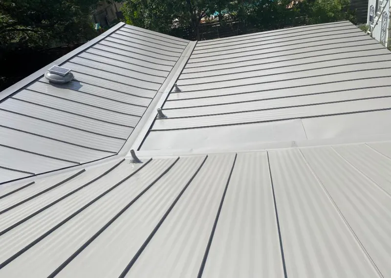 Solar attic fan installed on a metal roof for Roof Ventilation in Parma
